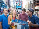 friends-looking-at-big-bus-tours-leaflet-in-times-square.webp